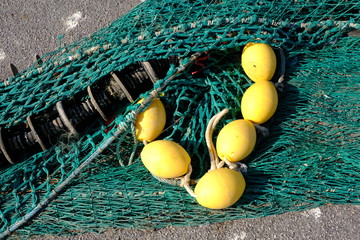 Colourful fishing floats, ropes and nets on a jetty © Jerry