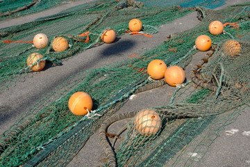 Colourful fishing floats, ropes and nets on a jetty