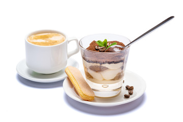 Classic tiramisu dessert in a glass cup, savoiardi cookies and coffee beans on white background with clipping path