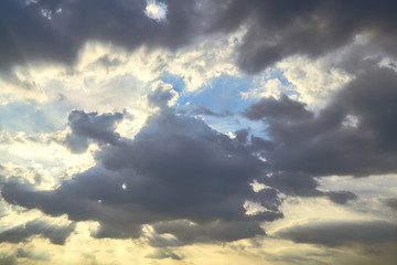 amazing sun light behind rainy cloud and blue sky background