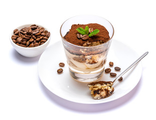 Classic tiramisu dessert in a glass cup on the plate on white background with clipping path