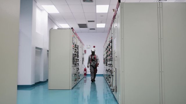 Engineer to check electrical power module in electricity substation , industrial and technology concept