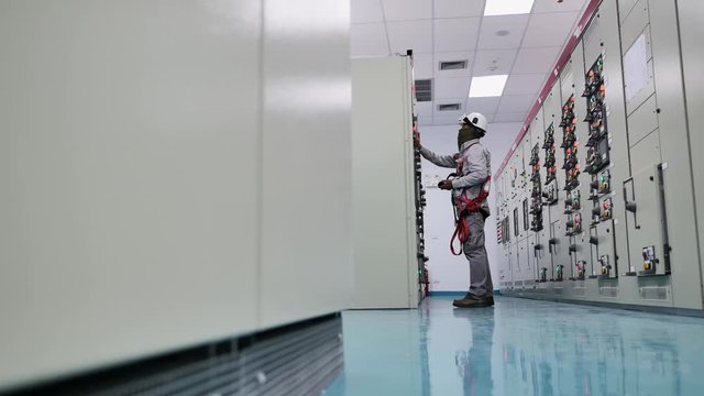 Engineer to check electrical power module in electricity substation , industrial and technology concept