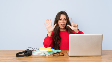 Teenager student girl studying in a table counting seven with fingers