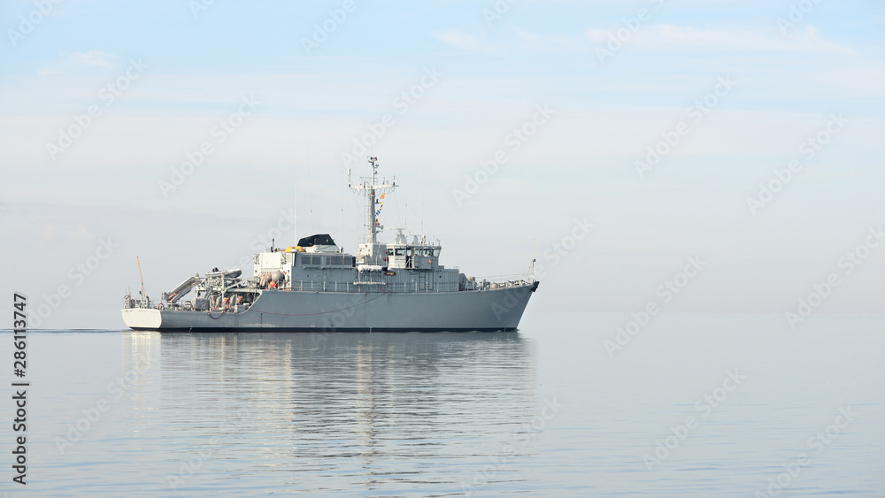 Canvas Prints Grey modern warship sailing in still water