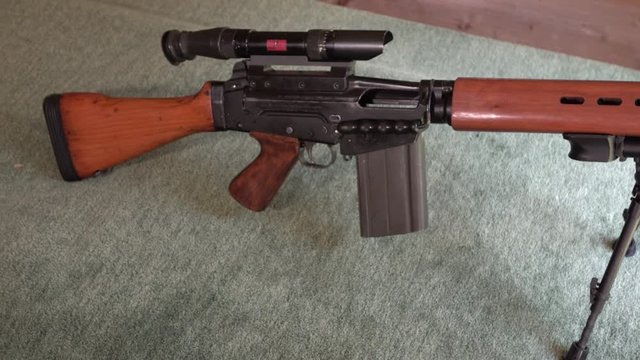 FAL rifle sitting idly on shooting range - wide
