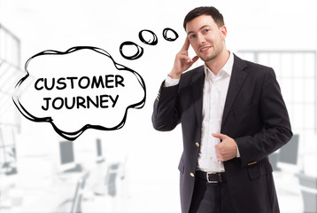 Business, technology, internet and network concept. The young businessman comes up with the keyword: Customer journey