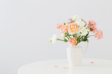 beautiful roses in ceramic white jug