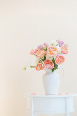 beautiful roses in ceramic white jug