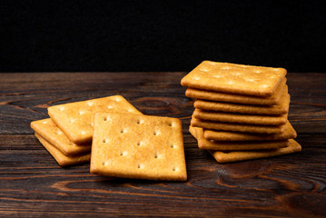 Cracker cookies with onion dark wooden background.