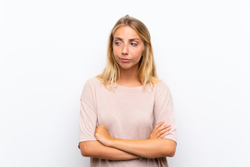 Blonde young woman over isolated white background thinking an idea