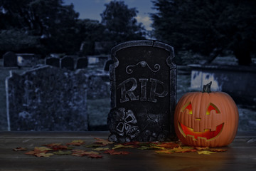 halloween pumpkin glowing in graveyard