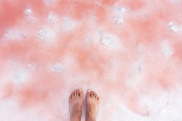 close up of high resolution texture of pink crystallized salt in a lake. space landscapes. Beatiful colors of nature. Travel photo background. Dried pink sea salt in the ground.