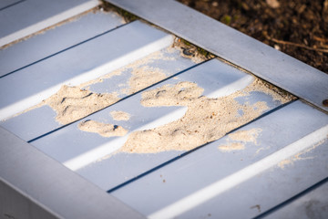 Construction sand on professional flooring remaining after workers.