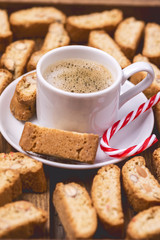 Cup of Espresso and Italian Almond Biscuit Biscotti and Candy Cane on Wooden Background Italian Dessert for Coffee or Wine Vertical Christmas Breakfast