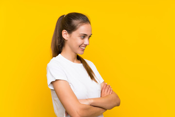 Obraz premium Young woman over isolated yellow background looking to the side