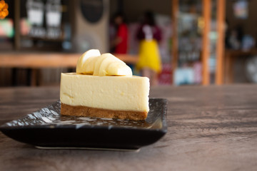 Cheesecake with topped Durian fruit and Durian cream on wooden desk background. Summer fruit for dessert in Thailand and Asia