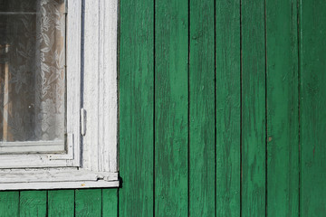 Obraz na płótnie Canvas Part of typical house in Lithuania, Trakai. Part of white window and green wooden wall.