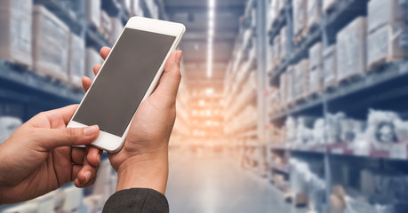 Hand woman holding smartphone to shopping online with blur storage background.