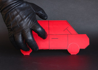 concept of theft of a car /A thief's hand approaches a car to steal it