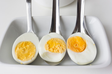 Sliced boiled eggs on spoons, Ready to eat.