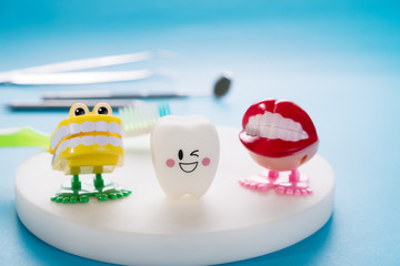 Obraz premium Dental tools and smile teeth model on blue background.