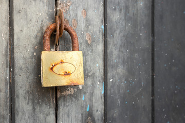 The Rusty lock with wood door, Old lock close home door.