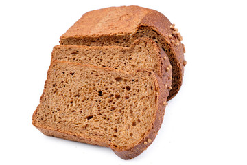 loaf of dark bread partly cut in slices, isolated on white