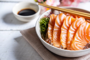 Salmon sashimi with soy sauce, raw fish in traditional Japanese style - obrazy, fototapety, plakaty