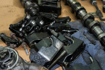 camshaft, bolts, nuts, rocker arm tappet valve taken from a broken car top view