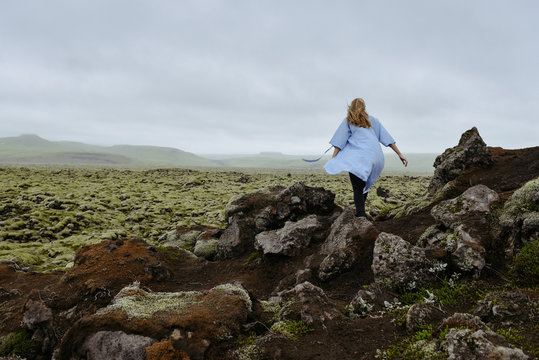 Young beautiful woman in an old moss-covered lava field  volcanic area in Iceland. Amazing nature