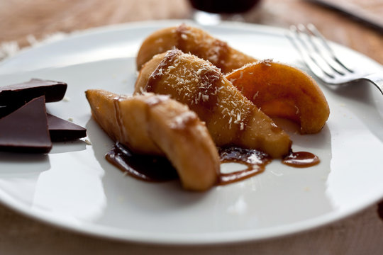Roasted pears with coconut butterscotch sauce served on plate