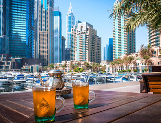 .Tea in traditional oriental cups. Panoramic view of Dubai, UAE.