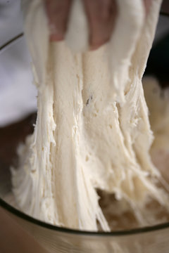 Close up on man's hand kneading dough