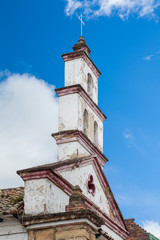 Fototapeta na wymiar Bell tower of the historical Chapel of San Antonio de Padua built on 1557 at the beautiful small town of Mongui in Colombia