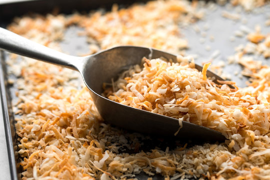 Close up of grated coconut in spatula