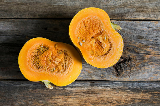 Overhead view of halved gourd on wooden table