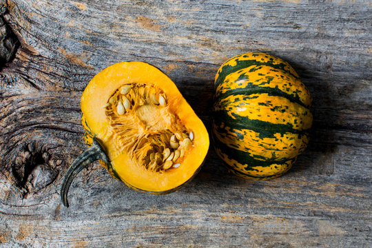 Overhead view of halved gourd on wooden table