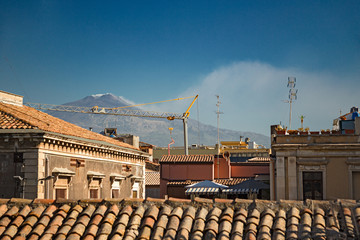 Panoramic view of the volcano Etna from the roofs of the historic center of Catania, in Sicily Italy.
