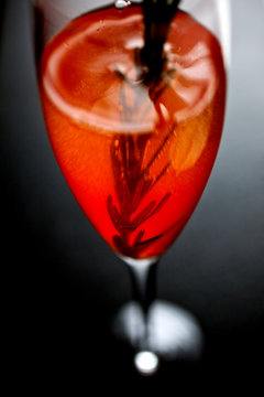 Close up of auld lang cocktail served with infused rosemary