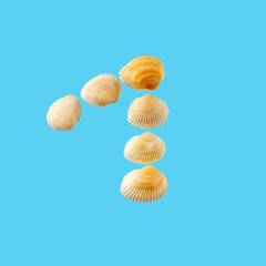 Fototapeta na wymiar Number one from sea shells isolated on tender light blue background