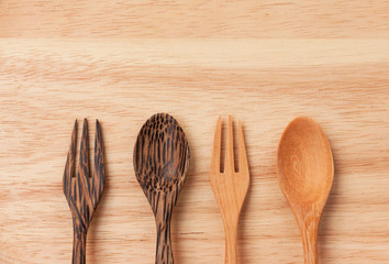 Design wooden fork and spoon on wood texture background