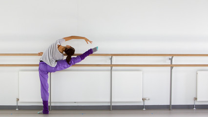 young ballerina stretching at ballet barre © andyross