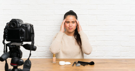 Young blogger Asian girl recording a video tutorial unhappy and frustrated with something. Negative facial expression