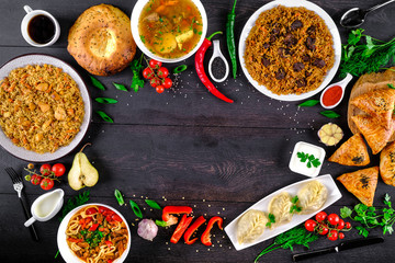 The concept of oriental cuisine. Assorted Uzbek food set, pilaf, samsa, lagman, manta, shurpa Uzbek restaurant concept, Uzbek food. Homemade Uzbek pilaf or plov from lamb served in cast iron cookware