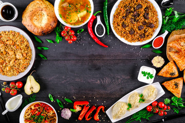 The concept of oriental cuisine. Assorted Uzbek food set, pilaf, samsa, lagman, manta, shurpa Uzbek restaurant concept, Uzbek food. Homemade Uzbek pilaf or plov from lamb served in cast iron cookware