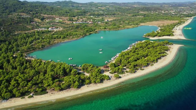 Aerial drone video of iconic sandy protected bay of Glarokavos with turquoise clear sea, Kassandra Peninsula, Halkidiki, North Greece
