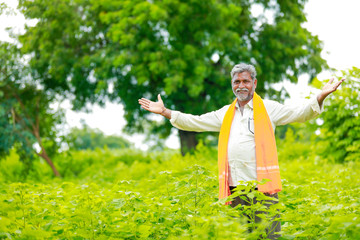 young indian farmer working at field