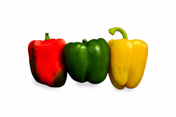 green, red and yellow bell peppers on white background