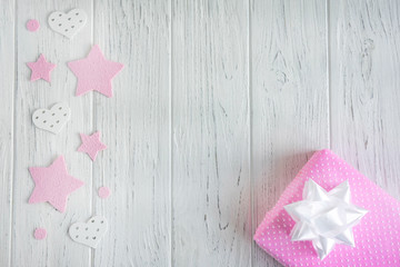 Greeting banner design with pink stars, hearts and a box with a gift. Frame for text congratulations for a girl, a newborn girl. Greeting card with a gift of pink color.